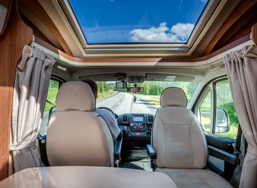 man-driving-on-a-road-in-the-camper-van-rv.jpg